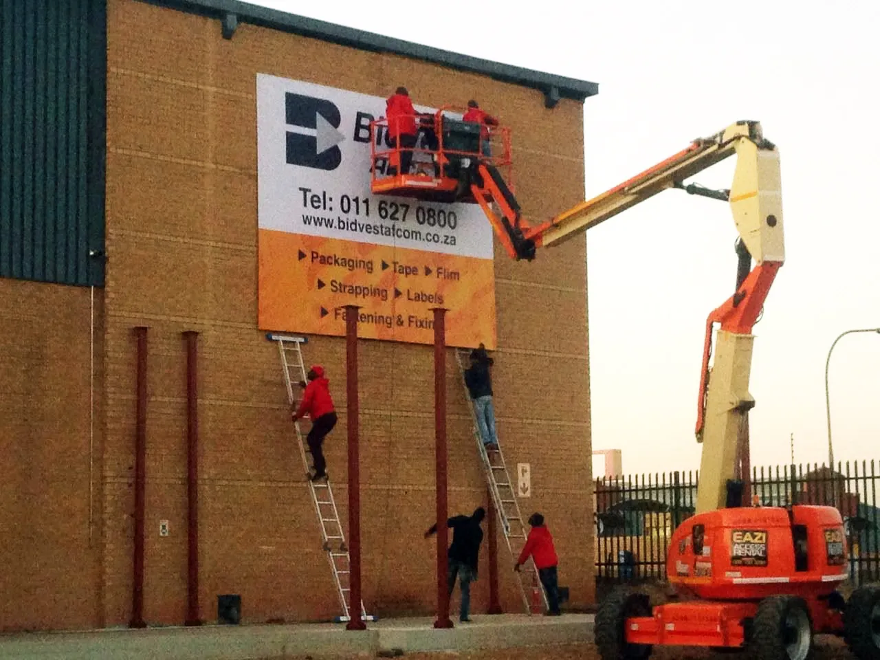 Stiek Industries installing exterior signage at height