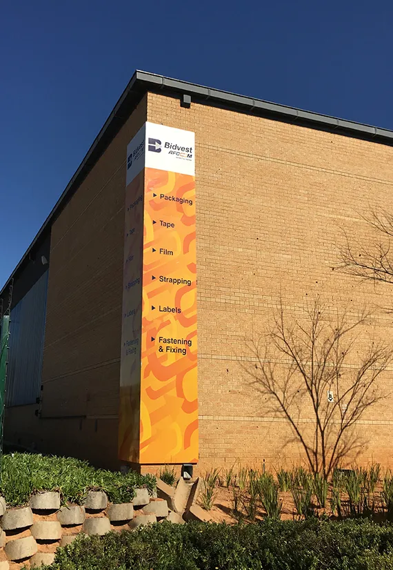 Working at height on an exterior install — signage and branding by Stiek Industries